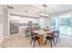 Modern kitchen with white cabinetry, stainless steel appliances, and a dining table with black chairs at 1085 Bevy Blvd, Danville, IN 46122