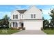 Charming two-story home with a front porch, attached two-car garage, and professionally landscaped yard at 1085 Bevy Blvd, Danville, IN 46122