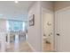 Hallway leading to the living room and a half bathroom, showcasing modern flooring and neutral tones at 1085 Bevy Blvd, Danville, IN 46122