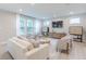 Beautifully furnished living room with a comfortable sofa, accent chairs, large windows, and contemporary entertainment center at 1085 Bevy Blvd, Danville, IN 46122