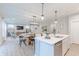 Open-concept layout with a kitchen island overlooking the dining area and living room with a TV at 1085 Bevy Blvd, Danville, IN 46122