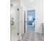 Bright bathroom with black and white patterned tile floor leading to the glass shower and an open bedroom at 1088 Bevy Blvd, Danville, IN 46122