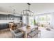 Open concept dining area featuring modern lighting, gray kitchen cabinets, and ample natural light at 1088 Bevy Blvd, Danville, IN 46122