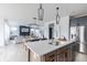 Open kitchen featuring stainless steel appliances, an island, and views of the living area at 1088 Bevy Blvd, Danville, IN 46122