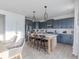 Well-lit kitchen with an island, stainless steel appliances, and modern gray cabinets at 1088 Bevy Blvd, Danville, IN 46122