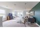 Spacious living room features large windows, a comfortable gray sofa, and stylish decor creating an inviting atmosphere at 1088 Bevy Blvd, Danville, IN 46122