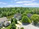 Aerial view of the home on the water surrounded by mature trees at 11061 Mast Ct, Fishers, IN 46040