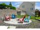 Backyard stone patio featuring outdoor seating, a grill, and manicured landscaping at 11061 Mast Ct, Fishers, IN 46040