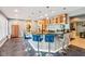 Finished basement bar with seating, wood cabinets, and stainless-steel appliances at 11061 Mast Ct, Fishers, IN 46040