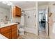 Bathroom featuring a tub, shower, wood cabinet, and open access to bedroom at 11061 Mast Ct, Fishers, IN 46040