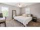 Neutral bedroom featuring carpet, two windows, neutral bedding, side tables, and a dark wood mirror at 11061 Mast Ct, Fishers, IN 46040