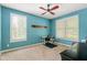 This bedroom features neutral carpeting, cool wall color, ceiling fan, and bright natural light at 11061 Mast Ct, Fishers, IN 46040