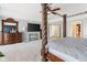Primary bedroom showcasing canopy bed, sitting area, and large windows at 11061 Mast Ct, Fishers, IN 46040