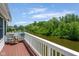 Deck view showing waterfront with adjacent homes and treelined horizon at 11061 Mast Ct, Fishers, IN 46040