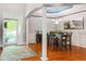Elegant dining room with hardwood floors, stylish chandelier, and open doorway leading to a sunlit exterior at 11061 Mast Ct, Fishers, IN 46040