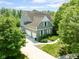 Two-story home showcasing a three-car garage and manicured lawn at 11061 Mast Ct, Fishers, IN 46040
