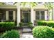 Inviting front porch area with stone steps, columns, and a beautifully decorated front door with surrounding greenery at 11061 Mast Ct, Fishers, IN 46040