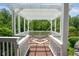 Outdoor pergola with a hammock overlooking a tranquil lake view at 11061 Mast Ct, Fishers, IN 46040