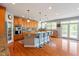 Beautiful kitchen featuring granite countertops, wood cabinets, a large island with seating, and stainless steel appliances at 11061 Mast Ct, Fishers, IN 46040