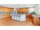 Well-appointed kitchen with wood cabinetry, granite countertops, a center island with bar seating, and hardwood floors at 11061 Mast Ct, Fishers, IN 46040