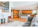 Spacious living room featuring hardwood floors, an open layout, and a view of the kitchen with bar seating at 11061 Mast Ct, Fishers, IN 46040