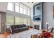 Bright and airy living room with high ceilings, large windows, a fireplace, and comfortable seating area at 11061 Mast Ct, Fishers, IN 46040