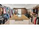 Expansive walk-in closet with custom shelving, center island, and ample storage space at 11061 Mast Ct, Fishers, IN 46040