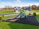 New playground in community surrounded by green space near houses, enhancing Gathering living at 1108 Bevy Blvd, Danville, IN 46122