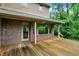 Expansive wooden deck with partial cover, overlooking the greenery and backyard of the home at 11469 Woodview Ct, Fishers, IN 46038