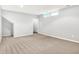 Unfinished basement showcasing neutral carpet and light gray walls, perfect for storage or future renovation at 11469 Woodview Ct, Fishers, IN 46038