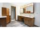 Bathroom featuring wood cabinets, double vanity and modern fixtures at 11469 Woodview Ct, Fishers, IN 46038