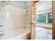 Bathroom with fiberglass tub and shower combo, and an open view to bedroom at 11469 Woodview Ct, Fishers, IN 46038