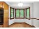 Bright breakfast nook featuring hardwood floors, bay window, and built in appliances at 11469 Woodview Ct, Fishers, IN 46038