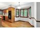 Cozy dining nook with hardwood floors, bay windows, and adjacent kitchen area at 11469 Woodview Ct, Fishers, IN 46038