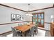 Formal dining room with a wooden table, seating for six, stylish decor, and large window at 11469 Woodview Ct, Fishers, IN 46038