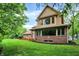 Two-story home with a brick facade, many windows, and green lawn at 11469 Woodview Ct, Fishers, IN 46038