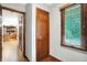 Hallway featuring hardwood floors, natural light, and wood trim at 11469 Woodview Ct, Fishers, IN 46038