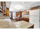 Traditional kitchen with wood cabinets, tile countertops, and center island cooktop at 11469 Woodview Ct, Fishers, IN 46038