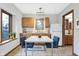 Bright eat-in kitchen featuring wood cabinets, large windows, stainless-steel sink, and a dining table at 11469 Woodview Ct, Fishers, IN 46038
