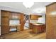 Open kitchen features wood cabinets, center island, and leads to staircase at 11469 Woodview Ct, Fishers, IN 46038