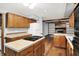 Kitchen with wood cabinets and island cooktop, open to living room with fireplace at 11469 Woodview Ct, Fishers, IN 46038
