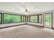 Bright living room featuring plush carpet, a ceiling fan, and large windows offering a peaceful view at 11469 Woodview Ct, Fishers, IN 46038