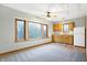 Bright living room with large windows, kitchenette area, and neutral walls at 11469 Woodview Ct, Fishers, IN 46038