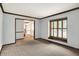 Living room with trimwork, neutral walls and carpet, and a pass-through opening at 11469 Woodview Ct, Fishers, IN 46038
