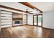 The living room has a fireplace, a ceiling fan, exposed beams, and wood floors at 11469 Woodview Ct, Fishers, IN 46038