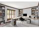 Well-appointed home office featuring built-in bookshelves, a spacious desk, and great natural light at 11469 Woodview Ct, Fishers, IN 46038