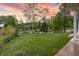 A backyard with a lush green lawn and mature trees provides a serene backdrop for outdoor activities at 11911 W Grandview Dr, Columbus, IN 47201