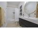 Modern bathroom with sleek vanity, round mirror, and shower/tub combination at 11911 W Grandview Dr, Columbus, IN 47201