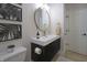 Stylish powder room featuring modern vanity, round mirror, and sleek fixtures at 11911 W Grandview Dr, Columbus, IN 47201