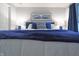 Comfortable bedroom with a luxurious blue bed, soft lighting, and stylish decor at 11911 W Grandview Dr, Columbus, IN 47201